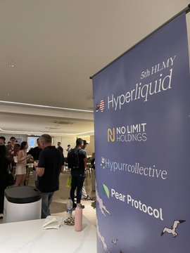 A vertical banner at the "5th HLMY" community event displays sponsor logos including Hyperliquid, No Limit Holdings, HypurrCollective, and Pear Protocol, with attendees mingling in the background of the indoor venue. The setup reflects the cat-themed ("meow lovers") gathering referenced in the post, showcasing the sponsoring crypto and DeFi brands supporting the event.