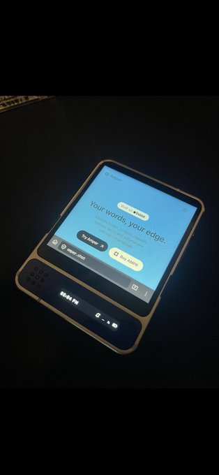 A handheld AI device labeled 'rabbit r1' displays a screen reading 'Your words, your edge' with 'Try Alpha' and 'Buy Alpha' buttons against a dark background.