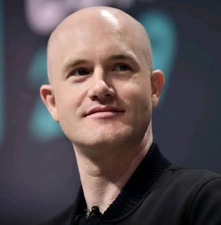 Headshot of a bald man in a black shirt smiling slightly at the camera, likely a CEO or public figure.