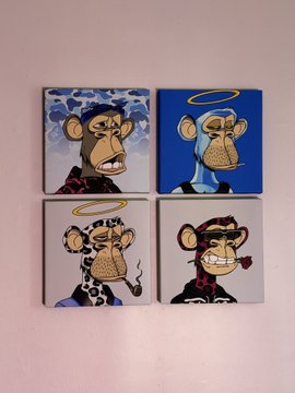 Four square stickers or coasters are arranged in a grid, each featuring a cartoon Bored Ape Yacht Club NFT character with different designs and accessories against various backgrounds.