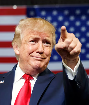Donald Trump, with the American flag in the background, is shown pointing forward in this image. This image is used to visually represent the subject of the accompanying news about Trump Media's Bitcoin holdings.