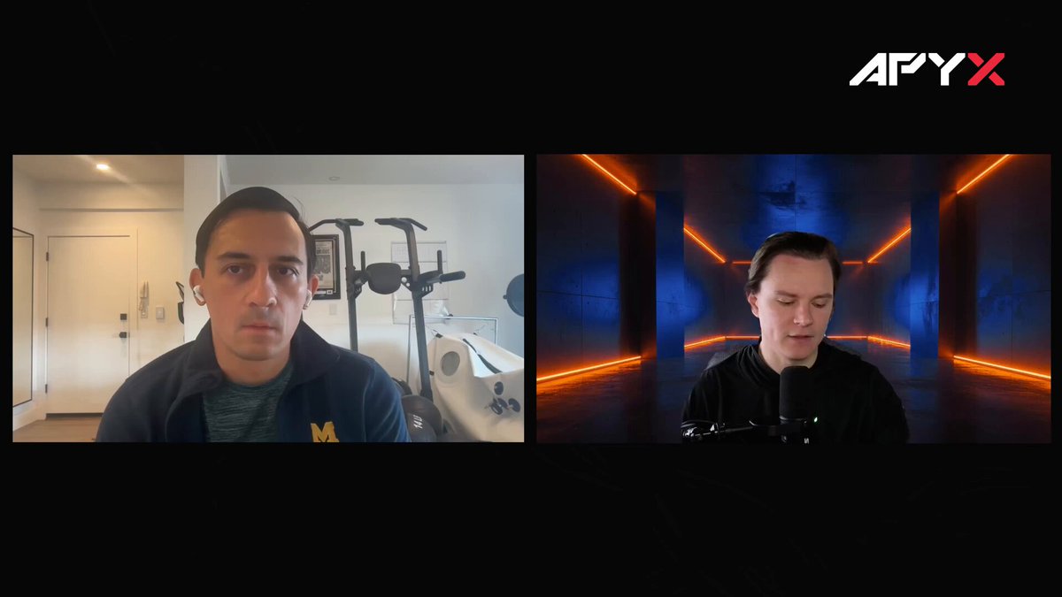 The image shows a man sitting at his computer, with another person's face displayed on the screen behind him. The two individuals appear to be engaged in a conversation or discussion about tokenized assets like $STRCx. This suggests that they might be discussing the potential of these assets as a foundation for new business models and innovative financial solutions.