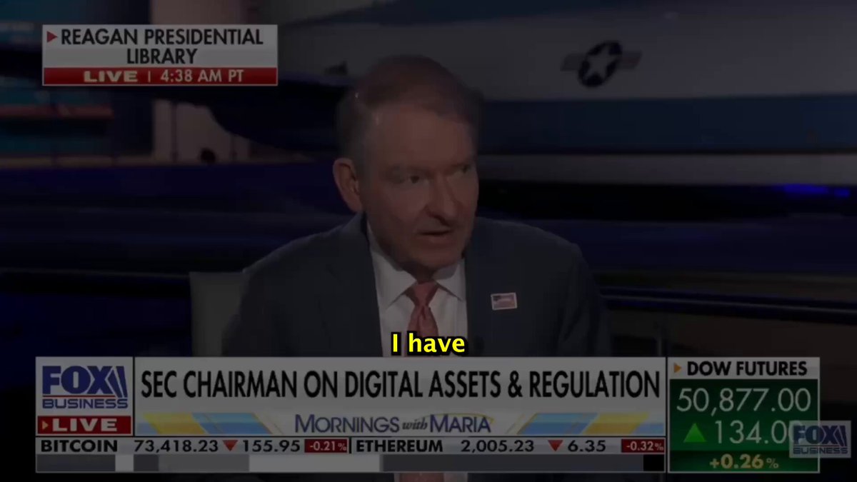 The image shows a news segment featuring a man sitting at a desk, wearing a suit and tie, with a TV screen behind him displaying the news program. The headline of the news story reads "Desperate Bank CEO issues CHILLING warning to crypto industry TimeStamps: 00:00 intro 01:12 JPMorgan CEO rips Coinbase CEO over Clarity Act 03:10 Coinbase Exec: 
"You are NOT bullish enough". This statement is made by a prominent figure in the cryptocurrency world, and it seems that the man sitting at the desk has something to say about the crypto industry. The image also includes a quote from the post, which reads "Focus on what is in the image and how it relates to the post", suggesting that there might be some connection between the news story being discussed and the content of the post.