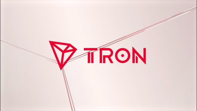 The image displays the TRON logo (a red diamond shape) and the word "TRON" on a light pink background. This branding connects to the post's message by visually anchoring the discussion of US crypto policy developments as a growth opportunity for the TRON blockchain network.
