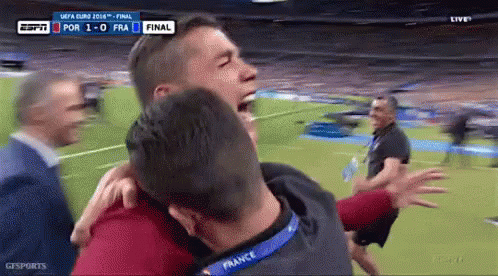 An ESPN broadcast screenshot showing two men in red France jerseys embracing emotionally on a soccer field, with the scoreboard showing 'POR 1 - 0 FRA FINAL'.