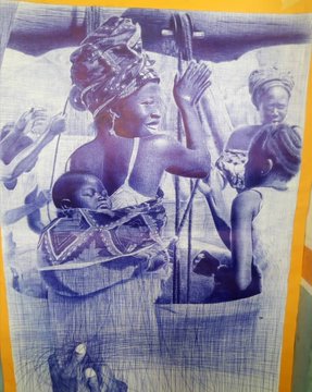 A sepia-toned photograph printed on fabric depicts African women and children in traditional dress, with one woman holding a baby in a sling.