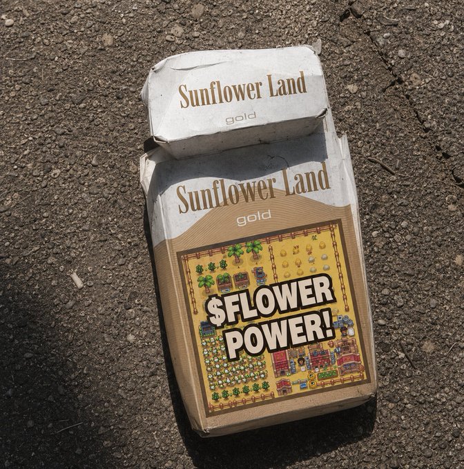 A discarded "Sunflower Land gold" cigarette pack featuring "$FLOWER POWER!" branding lies on dirt, playfully riffing on the post's joke about the @0xSunflowerLand token being packaged as a smoke product.