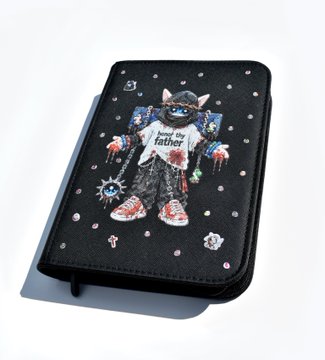 A black wallet-style phone case decorated with rhinestones, featuring an embroidered cat wearing a white shirt that reads 'howl the father' along with chains and small charm details.