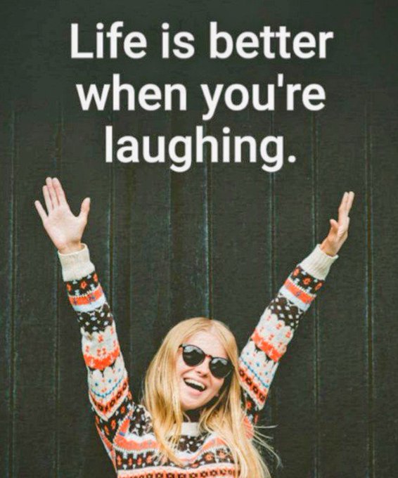 A blonde woman wearing sunglasses and a patterned sweater joyfully raises her arms against a dark background, with white text reading 'Life is better when you're laughing.'