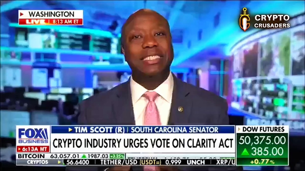The image shows a man wearing a suit, sitting at a desk with a computer screen behind him. The news anchor is reporting about a CryptoIndustry Urges Vote On clarity Act that has been introduced by the Senate. This act would require companies to provide clear and transparent information about their cryptocurrency operations on a public platform. The post also mentions Bitcoin, which is likely related to the Cryptocurrency industry in some way.