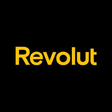 The image shows the Revolut logo in yellow text on a black background, representing the fintech company that has received conditional U.S. national bank charter approval and plans to launch its U.S. bank operations by early 2027.