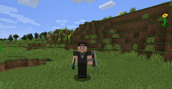 A Minecraft character wearing a black outfit and holding items stands in a grassy, blocky landscape with a terraced hill in the background. The scene reflects the player's avatar in the XPR Network game, as mentioned in the post.