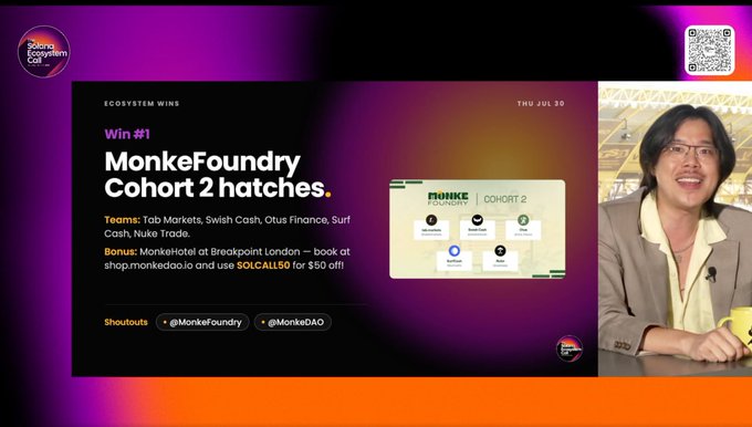 A screenshot of a video presentation about 'ECOSYSTEM WINS' titled 'MonkeFoundry Cohort 2 hatches,' featuring a presenter in a yellow shirt and beige jacket, with shoutouts to @Monkefoundry and @MonkeDAO.