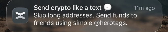 A notification banner with the XRP logo that reads 'Send crypto like a text' and 'Skip long addresses. Send funds to friends using simple @herotags,' posted 11m ago.