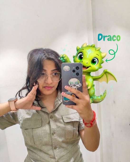 A woman takes a mirror selfie with a cute green dragon sticker labeled "Draco" beside her, fitting the post's theme as Draco the dragon mascot is introduced as the guardian of the zkSchool platform, teasing new certificates, privacy courses, and the August Quest.