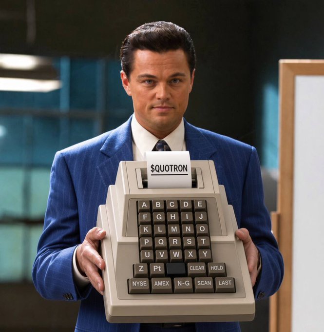 Leonardo DiCaprio in a blue pinstripe suit holding a large vintage "$QUOTRON" stock ticker machine with buttons for NYSE, AMEX, N-G, SCAN, and LAST.
