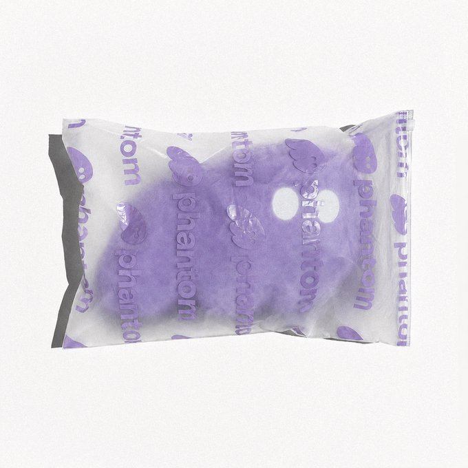 A purple plush toy, branded with "phantom," is packed in a clear bag with repeated "phantom" logos. The image directly relates to the accompanying post "bags are packed. send it…" by showing the item is indeed packed and ready to be sent.