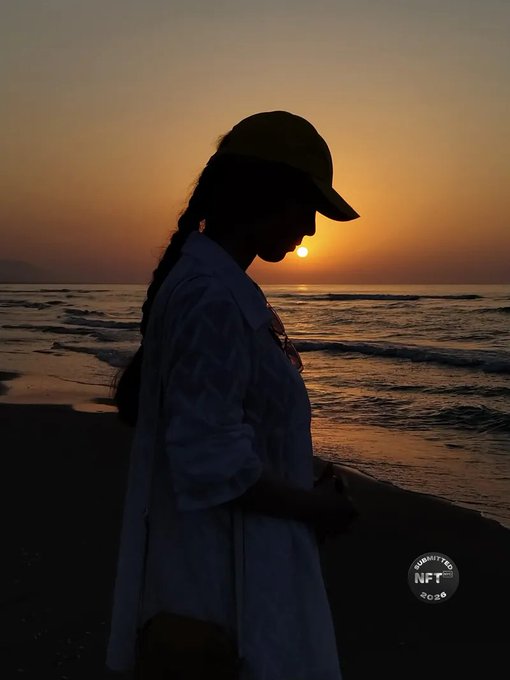 A silhouette of a person wearing a cap and long shirt standing on a beach at sunset, with a 'YEHEY! NFT 2022' logo in the bottom right.