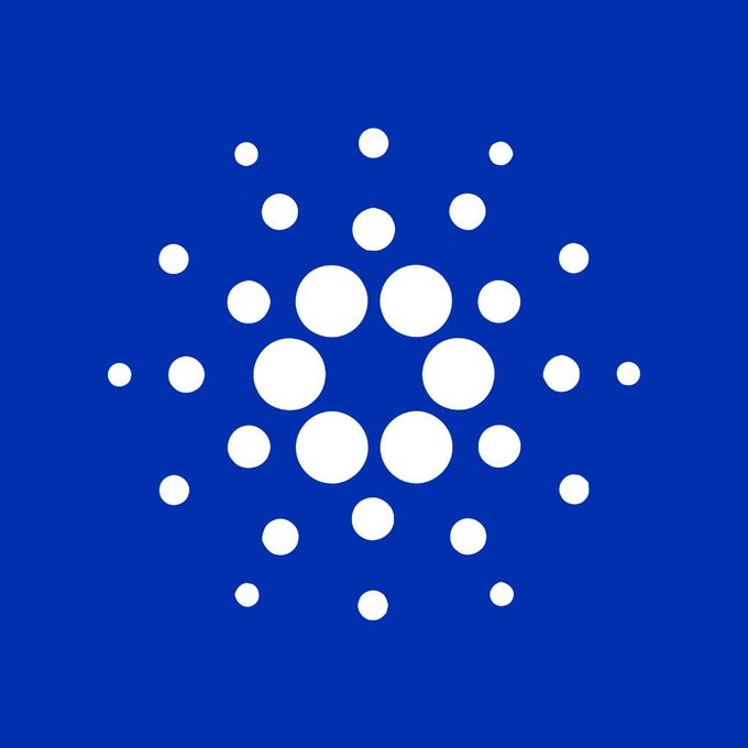 The Cardano cryptocurrency logo, consisting of a circular arrangement of white dots on a solid blue background.