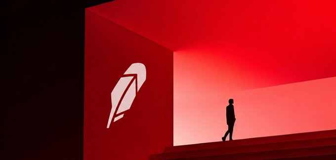 A stylized red and black scene showing a silhouetted figure walking up stairs in a red-lit room, with a large white feather pen logo on the left wall.