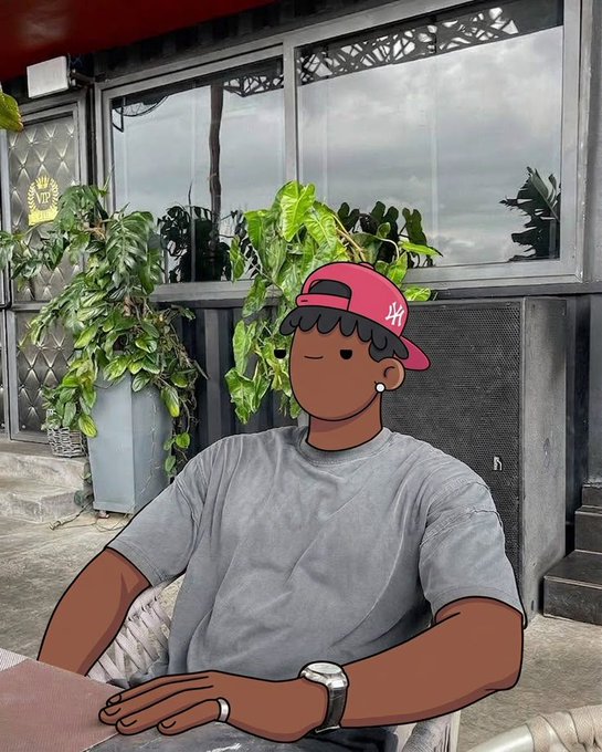 A cartoon-style filter is applied to a man wearing a red NY baseball cap and gray t-shirt, sitting at an outdoor cafe table with potted plants behind him.