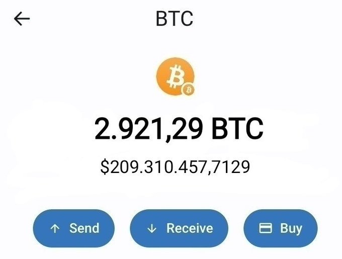 A screenshot of a Bitcoin wallet displaying a balance of 2.921,29 BTC ($209,310,457,7129) with Send, Receive, and Buy options. The image is being used to falsely suggest the poster has the means to give away 0.1 BTC (~$8,103) in a giveaway, but the absurdly high balance shown actually indicates the screenshot is fake or manipulated, as no individual would possess over $209 billion in Bitcoin.