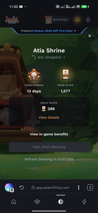 A mobile screenshot of the Axie Infinity 'Atia Shrine' page showing the user 'Ninpou 2026 AXP PLS' has a 13-day streak and 1,577 SLIPS, with a button to 'Gain Atia's Blessing'.
