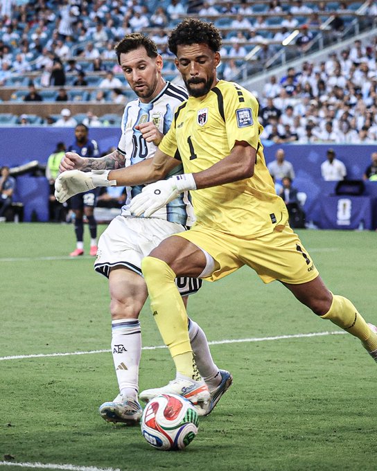 Two footballers battle for the ball during a Copa América match, with the goalkeeper in a yellow #1 jersey defending against an opponent in a light blue and white striped #10 jersey from Argentina. The post doesn't relate directly to the image content, but appears to reference Cape Verde's remarkable underdog story at the FIFA World Cup alongside this competitive international football moment captured between the players.