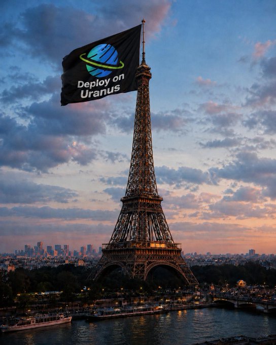The image features a large black Eiffel Tower, which has been altered into an advertisement for "Deploy on Uranus". The tower's base is now adorned with a blue planet logo, and the words "Deploy on Uranus" are displayed above it in white text. Below the tower, there is a river flowing through Paris, adding to the overall atmosphere of the scene. In the background, you can see buildings that make up the cityscape, providing context for the location where this advertisement was created. The image also includes a watermark at the bottom, indicating that it may have been sponsored by "Uranus".