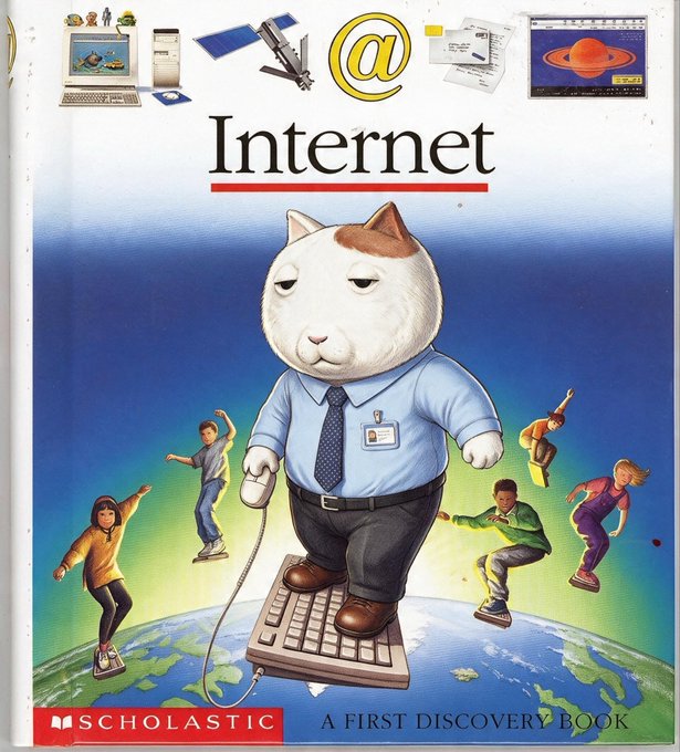 The cover of the Scholastic children's book "Internet: A First Discovery Book" features an anthropomorphic cat in business attire standing on a keyboard atop a globe, surrounded by people surfing on smaller keyboards, with icons of computers, satellites, emails, and video editing at the top. The image humorously illustrates the "who controls the memes controls the universe" sentiment by depicting internet technology as a powerful, world-dominating force literally standing on top of the Earth.