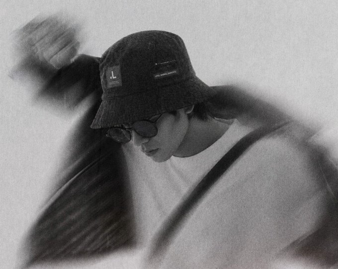 A grainy black-and-white photo shows a person wearing a dark bucket hat with a visible "L" patch and "CHRISTIAN" text, along with small sunglasses, looking downward with a contemplative expression.

The moody, introspective portrait complements the post's hopeful "gm ct, may we win today" greeting, capturing a reflective morning energy before facing the day's challenges.