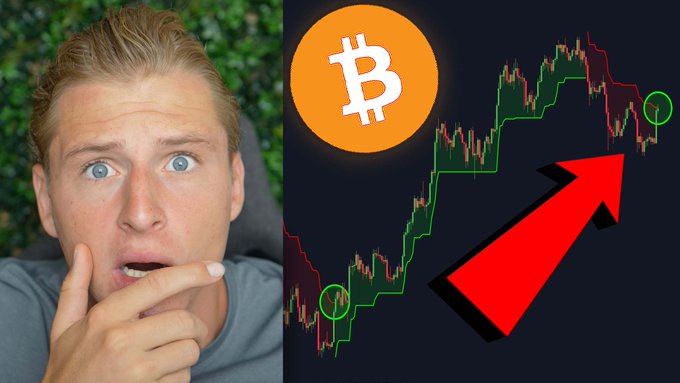 A shocked-looking blonde man gazes at a Bitcoin (₿) price chart showing an upward trend with a large red arrow, promoting a YouTube video urging Bitcoin holders to watch immediately for important information.