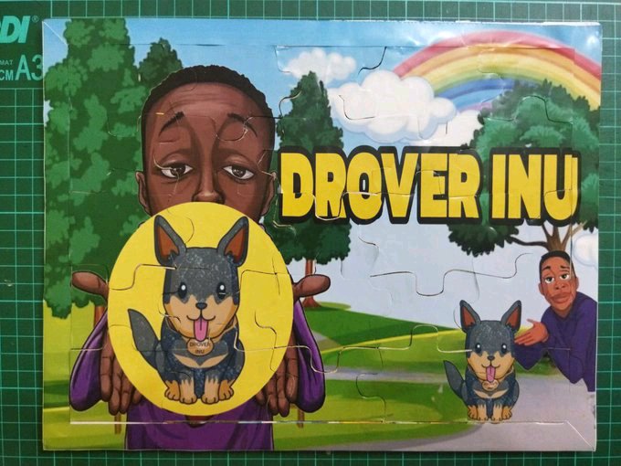 A jigsaw puzzle depicting 'DROVER INU' cryptocurrency meme, showing a Shiba Inu dog being held by a person, with a colorful cartoon landscape and rainbow in the background.