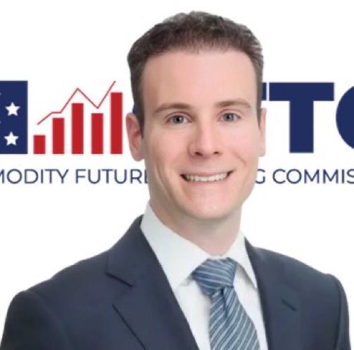 A smiling young man in a dark suit and striped tie is pictured in front of a CFTC (Commodity Futures Trading Commission) backdrop, suggesting he is a CFTC staff member or official. The image relates to the post as it visually represents the agency issuing the updated FAQs on crypto assets and blockchain technologies for registrants and registered entities.