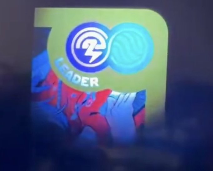 A blurry image showing what appears to be an app icon with "LEADER" text and a lightning bolt symbol over a character illustration.