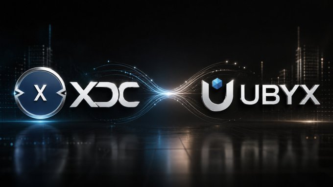 Promotional graphic featuring the logos for XDC and UBYX cryptocurrency projects against a dark city skyline background with glowing blue light effects connecting them.