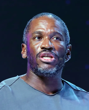 Arthur Hayes, the co-founder of BitMEX cryptocurrency exchange, speaks at an event, his expression serious as the post attributes a quote to him warning about continued money printing and government spending.