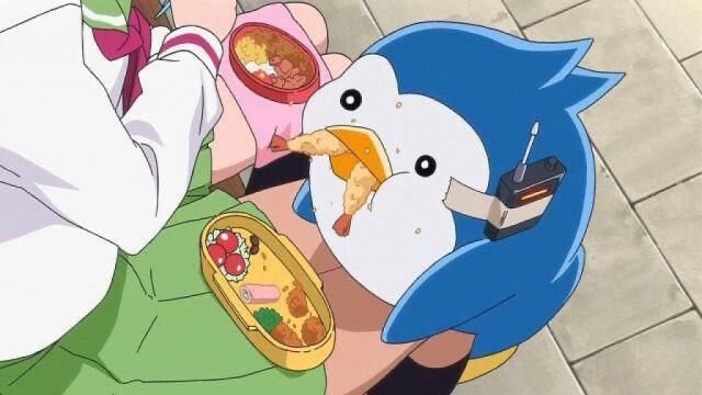 An anime scene depicting a round, blue and white penguin-like creature happily eating a fried shrimp while holding a drink, sitting next to bento boxes on someone's lap.