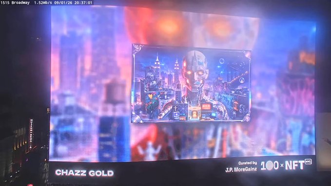 A Times Square billboard displays NFT artwork titled 'CHAZZ GOLD' curated by J.P. MoreGainz (100 x NFT), featuring a futuristic cityscape with a robotic face.