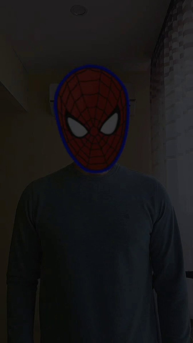 The image features a man wearing a Spiderman mask, which has been drawn with a red outline against his face. The mask covers most of his face, making him appear as if he's wearing a mask while taking a picture. The background is dark, creating an interesting contrast between the man and his surroundings. The caption to the image reads "ALPHA is here Subzero Labs just announced Latch, built on @RialoHQ The future belongs to agents, so we need a reliable tool to manage them securely".