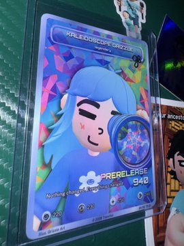 A colorful trading card displays a 'KALEIDOSCOPE GAZER' holographic-style character with blue hair, marked as a prere.