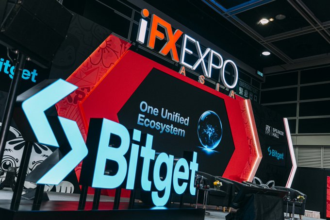 Bitget's illuminated booth displays "iFX EXPO ASIA" and "One Unified Ecosystem" branding, showcasing the crypto exchange's presence at the industry conference as it celebrates another trad-fi award.