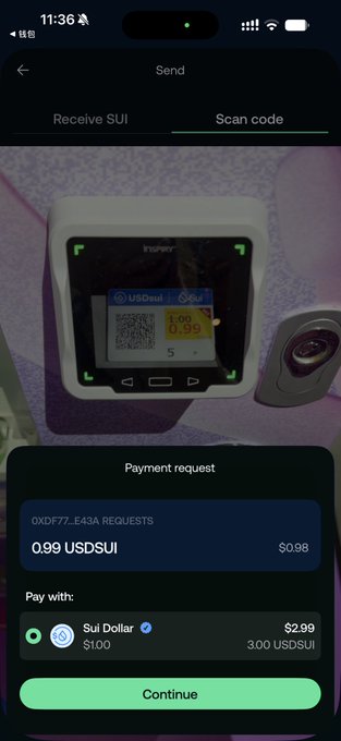 A mobile crypto wallet app on an iPhone showing a payment request of 0.99 USDSUI, with the camera viewfinder aimed at a point-of-sale device displaying 'USDsui' and prices like '1.00' and '0.99'.