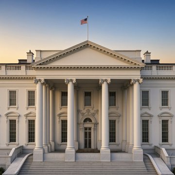 The White House is shown at dusk with its illuminated neoclassical facade and American flag flying above. The image relates to the post as it depicts the seat of executive power where policy decisions on banking and stablecoin regulation originate, contextualizing the news about the White House's upcoming tool to counter banking groups' concerns about deposit flight ahead of the Senate's Clarity Act vote.