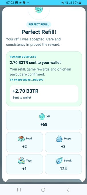 A smartphone screenshot of a "PERFECT REFILL" screen showing a reward of "2.70 B3TR sent to your wallet" along with +68 XP, +2 Food, +3 Drops, +1 Toys, and a 124 Streak.