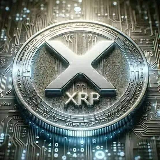 A close-up of a metallic XRP cryptocurrency coin with its distinctive 'X' logo resting on a circuit board.
