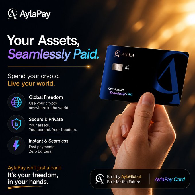 A hand holds the AylaPay Card, a sleek dark blue card featuring the Ayla logo and the tagline "Your Assets, Seamlessly Paid," promoting the card's key benefits: Global Freedom, Secure & Private, and Instant & Seamless crypto spending. The advertisement, built by AylaGlobal, visually reinforces the post's message by presenting the AylaPay Card as the bridge between crypto holdings and real-world spending, fulfilling the promise of "one card, real utility."