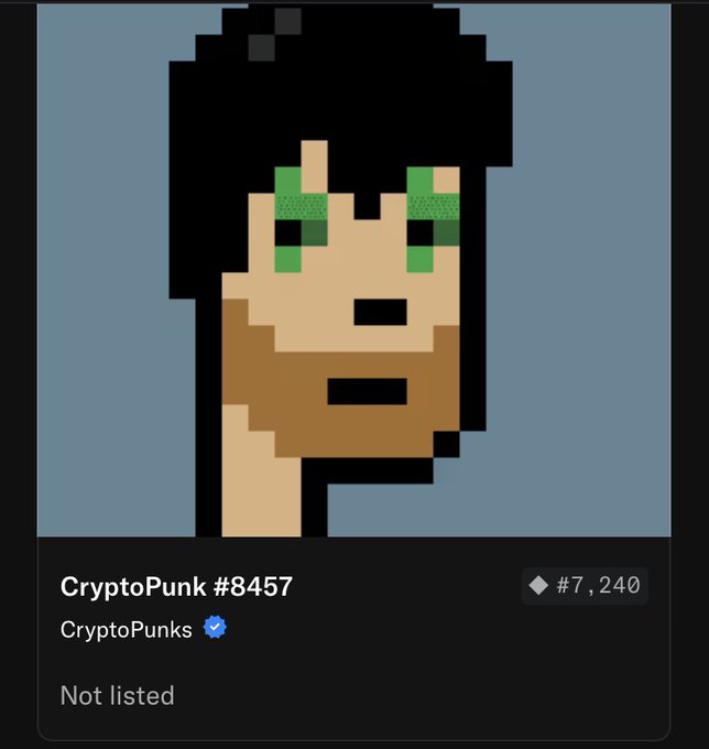 The image features a digital art piece that depicts an anthropomorphic character with a beard, green eyes, and black hair. The character appears to be wearing a hat and has a serious expression on their face. The image also includes text that reads "cryptopunks" and "84767", which may indicate the artist's name or the title of the artwork.