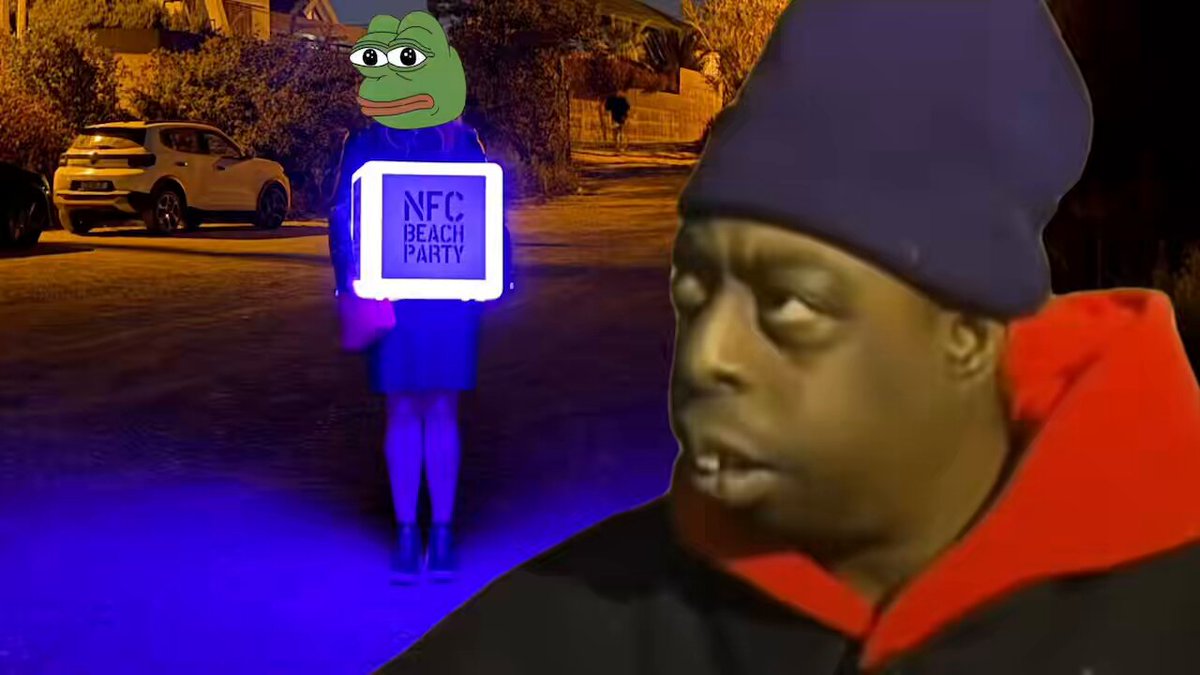 The image features a man wearing a black jacket, holding a neon sign that says "NFC Party" with a cartoon frog face on it. The man appears to be standing outside at night, possibly attending an event or gathering related to the "NFC Party." In the background, there is another person who seems to be looking at the man and his sign. A car can also be seen in the image, parked nearby.