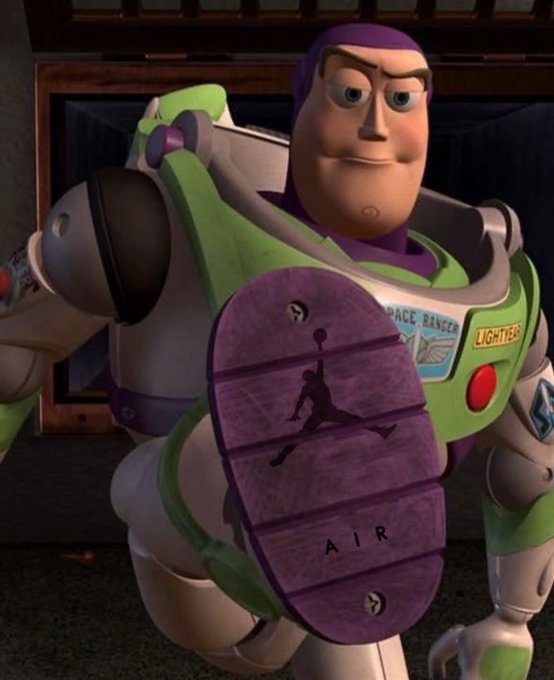 A Buzz Lightyear action figure showing the purple underside of his foot with a black silhouette of the Jumpman logo and the word 'AIR' molded into the sole.
